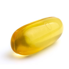 Omega 3 supplement, fish oil yellow capsules isolated on white background, macro image