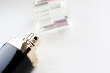 opened black perfume bottle on white background
