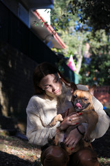 Obraz premium Friendship between a young pretty woman and a French Bulldog