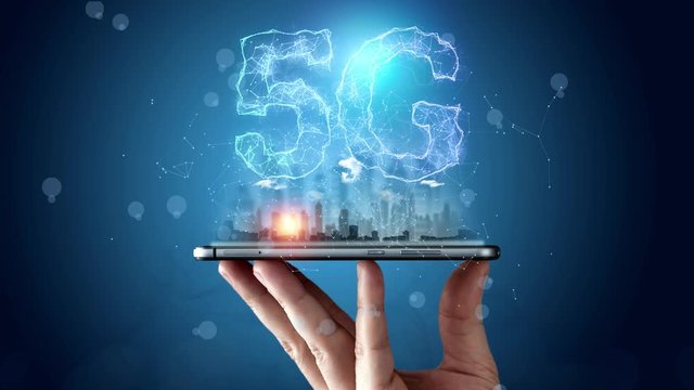 Animated 5G logo on a blue particles background, in a male hand a phone, close-up. The concept of 5G network, high-speed mobile Internet, new generation networks.
