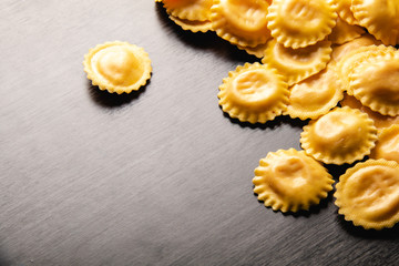 Cooking italian ravioli on wooden table. Top View with Copy Space.