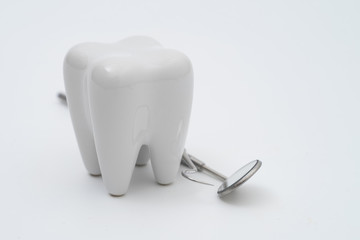 Teeth model and dentist tool on white