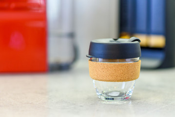 Reusable glass coffee cup in the kitchen. Zero waste concept. Bring your own takeaway cup.