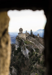 Cesta or De La Fratta tower view in San Marino from the  arrowslit in First fortress (Guaita).- Image