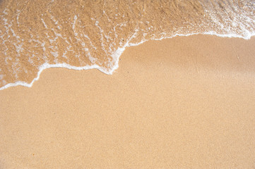 Fototapeta na wymiar Background with a sea wave in the sand