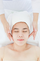 Asian young woman getting spa treatment at beauty salon. spa face massage. facial beauty treatment
