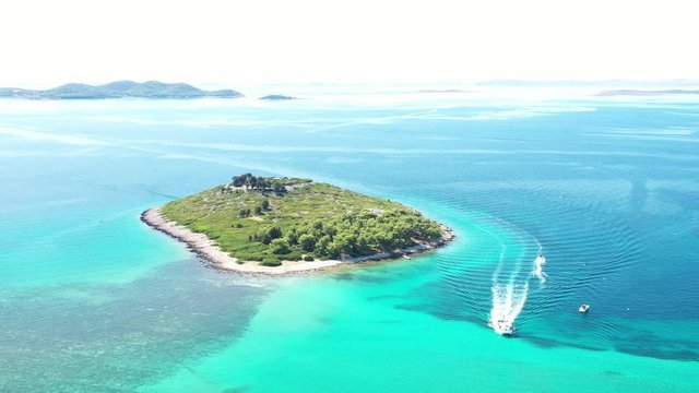 Beautiful blue seascape, small islands and boat on Adriatic sea in Croatia near Pakostane, drone aerial footage