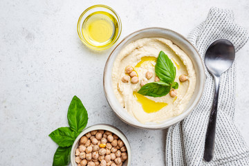 Bowl of healthy homemade creamy chickpea hummus dip with olive oil, top view - obrazy, fototapety, plakaty