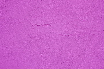 Old peeling paint on the wall. Purple  abstract background. Beautiful purple textured stucco on the wall. Background from purple stucco.