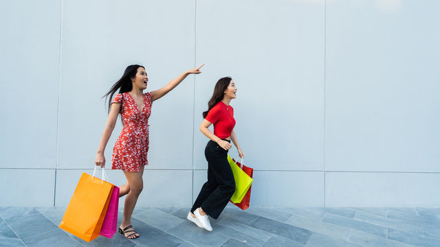 Asian Woman Friend They Are Shopping At The Mall. Happily