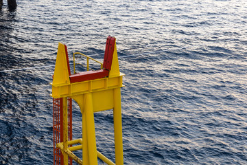 Crane boom rest on board a construction work barge at oil field