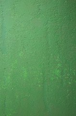Old peeling paint on the wall. Green abstract background. Beautiful green textured stucco on the wall..Background from green stucco.
