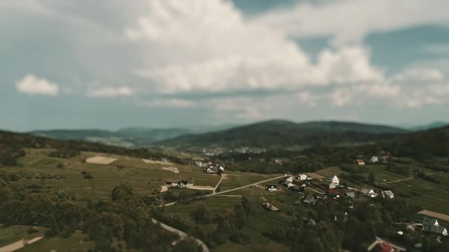 Dreamy, fantasy tiny model village. Aerial footage of typical Polish village with tilt-shift lens effect for shallow depth of field.