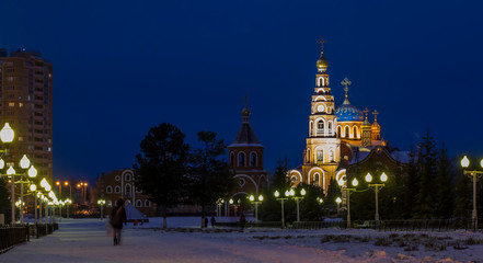 Fototapeta na wymiar View of the Orthodox Church of the night city. Panorama of night lights of the city
