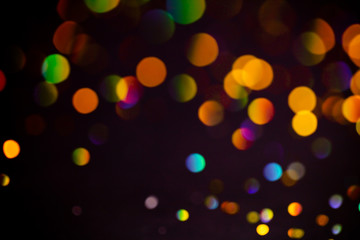 Multicolor glitter raster background. Abstract shimmering red circles on deep purple backdrop. Vibrant bokeh lights effect festive illustration. Overlapping glowing and twinkling spots.