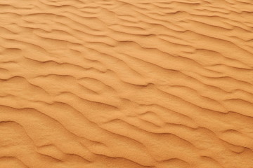 Fototapeta na wymiar Desert sand wave patterns for a warm and summer background