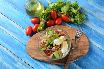 Tuna salad with lettuce, eggs and tomatoes, cucumber, corn and red onion. Healthy Mediterranean food concept