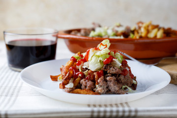 Traditional cuban potatoes with minced meat, lettuce and onion