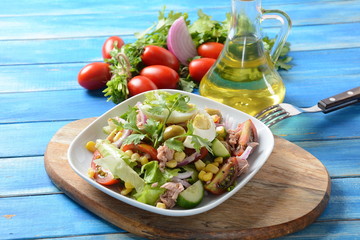 Tuna salad with lettuce, eggs and tomatoes, cucumber, corn and red onion. Healthy Mediterranean food concept