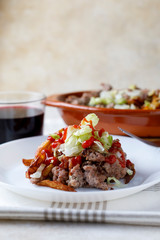 Traditional cuban potatoes with minced meat, lettuce and onion