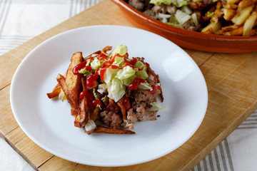 Traditional cuban potatoes with minced meat, lettuce and onion