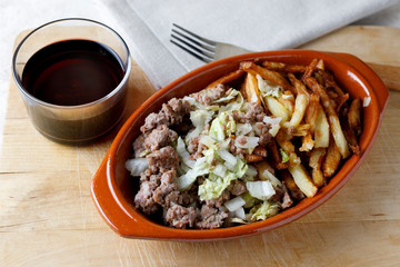 Traditional cuban potatoes with minced meat, lettuce and onion