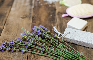 Spa body and legs treatment objects and salt heart with lavender over wooden background	