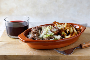 Traditional cuban potatoes with minced meat, lettuce and onion