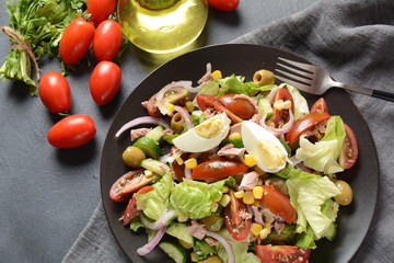 Tuna salad with lettuce, eggs and tomatoes, cucumber, corn and red onion. Healthy Mediterranean food concept