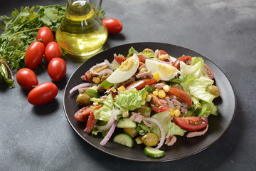 Tuna salad with lettuce, eggs and tomatoes, cucumber, corn and red onion. Healthy Mediterranean food concept