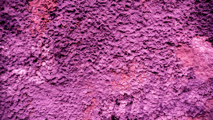 Old peeling paint on the wall..Purple abstract background. Beautiful purple textured stucco on the wall. Background from purple stucco.