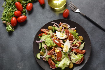 Tuna salad with lettuce, eggs and tomatoes, cucumber, corn and red onion. Healthy Mediterranean food concept
