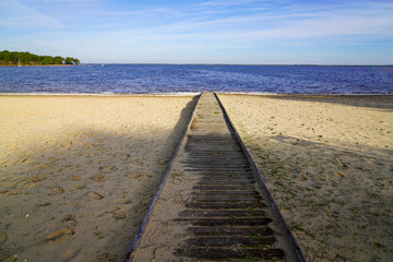 wooden access beach in sand pontoon on Lake Hourtin in Gironde france