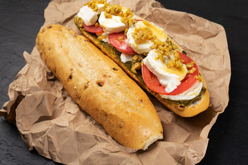 Goat cheese and honey sub sandwich on dark background