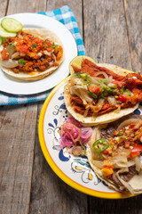 Mexican tacos on wooden background