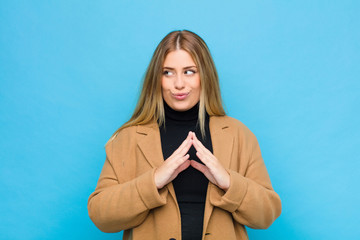 young blonde woman scheming and conspiring, thinking devious tricks and cheats, cunning and...
