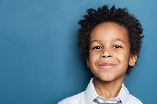 Happy kid portrait. Cute black child smiling and looking at camera