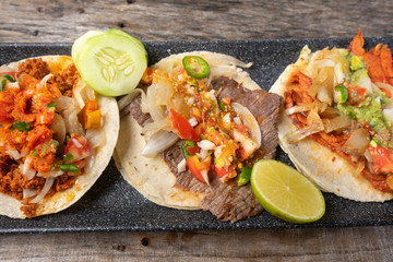 Mexican tacos on wooden background