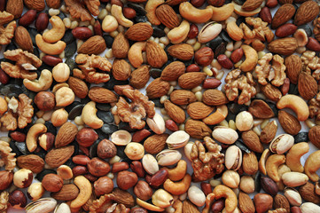 background of assorted different nuts on a white background