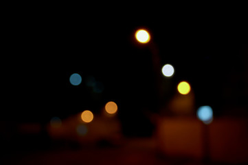 Fototapeta premium Abstract blurred background of evening city.Night traffic,colorful lights. Night city street lights bokeh background. Abstract background for greeting cards