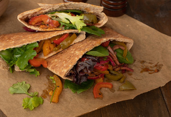 Pita bread pockets filled with  roasted bell peppers and greens