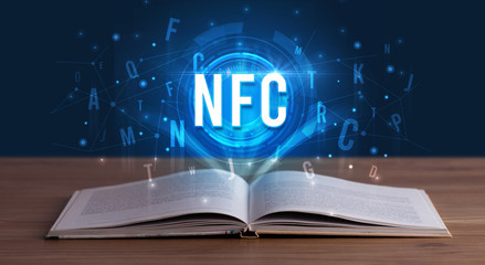 NFC inscription coming out from an open book, digital technology concept