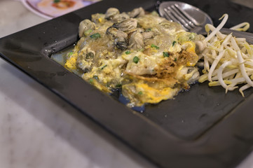 Fried mussel pancakes, Cooking mussel fried in egg batter. Street food of Thailand.