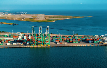 Oakland Harbor port terminal with shipping containers and cranes