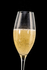 a golden ring in a glass with champagne, many bubbles, like a marriage proposal