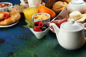 Breakfast served with coffee, orange juice, croissants, cereals and fruits. Balanced diet. Continental breakfast with granola and fruits
