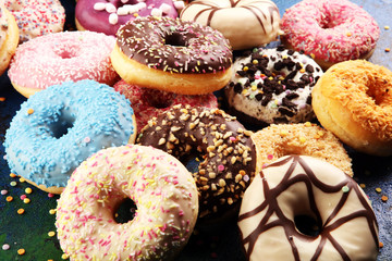 assorted donuts with chocolate frosted, pink glazed and sprinkles donuts