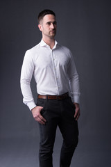 Fototapeta premium young man in a white shirt and dress pants