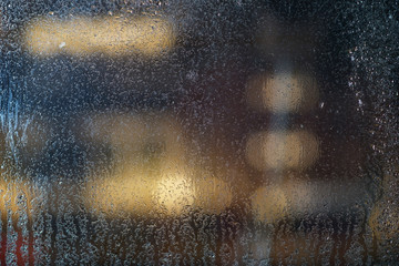 Condensation and rain drops on the wet glass window