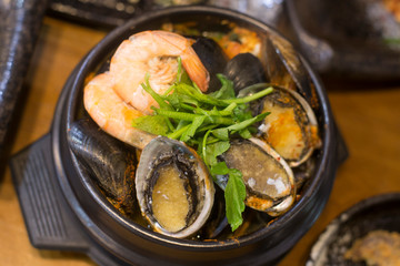 Korean seafood ttukbaeg. Abalone earthen pot stew.